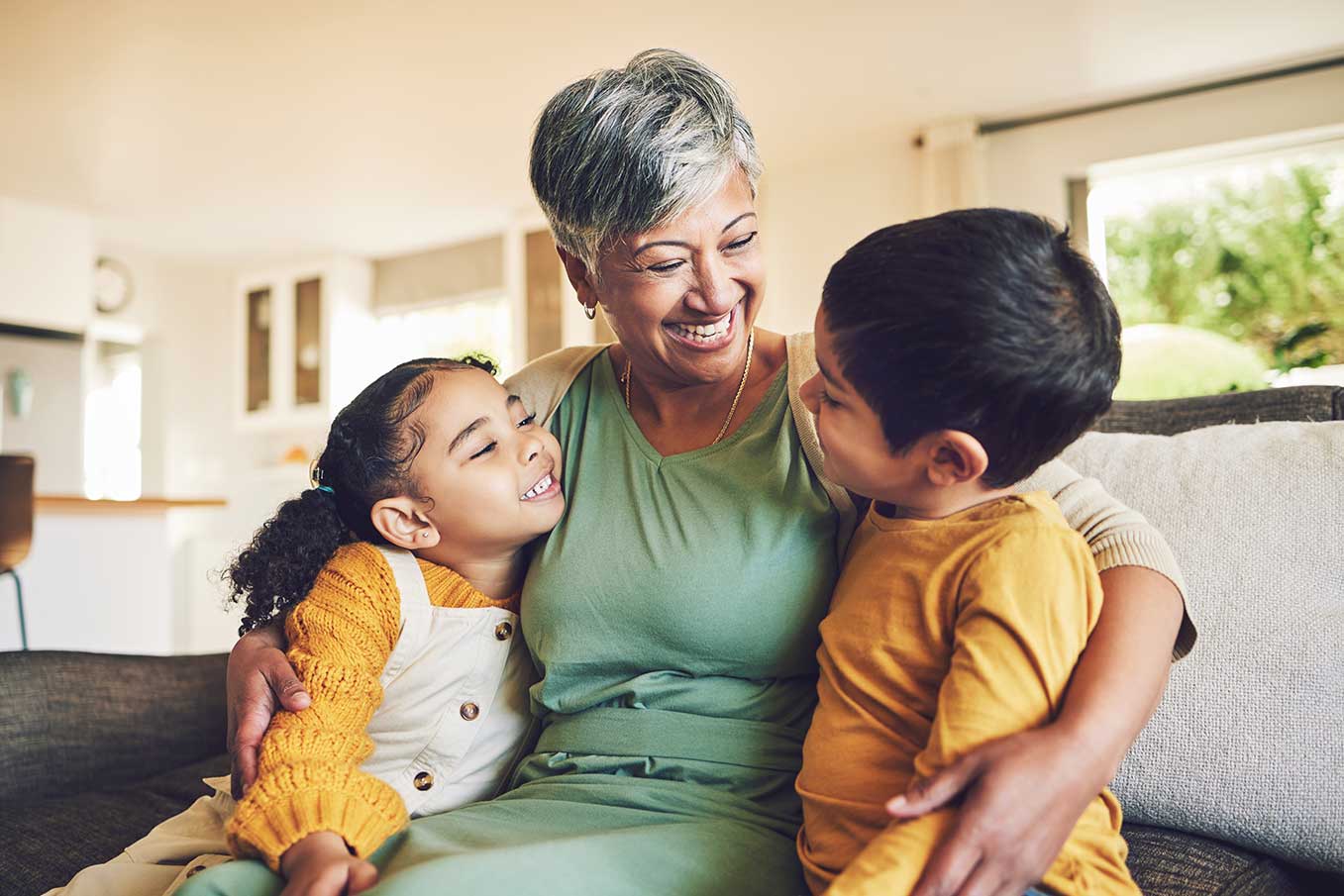 Image of a smiling senior with her grandchildren